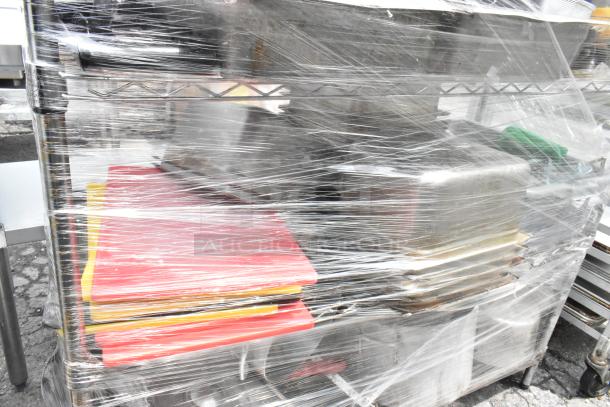 Chrome finish 4-tier wire shelving with colanders, drop-in bins, and stock pots. Buyer must dismantle. Wrapped for shipping.