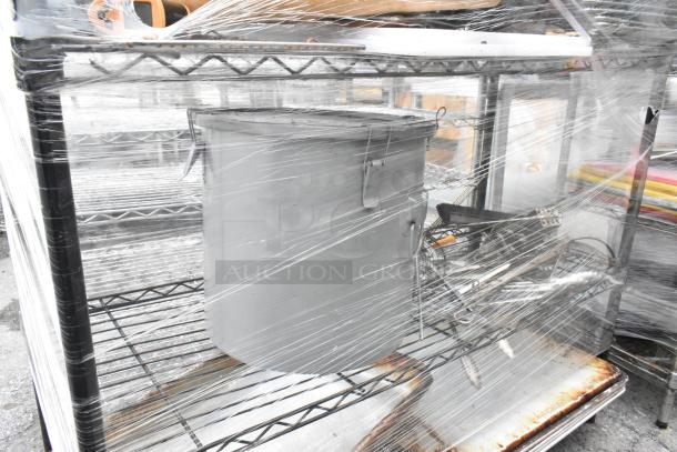 Black four-tier wire shelving unit with contents; includes utensils, rolling pin, metal pans. Buyer must dismantle.