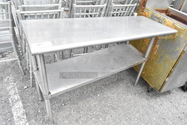 Stainless steel table with metal under shelf, rectangular shape, shows signs of use, labeled "263" on top corner.