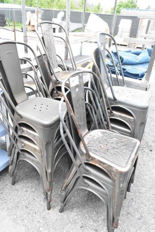 Stacked metal Tolix-style dining chairs, weathered condition. Set of 17, each multiplies the bid by 17. Marked with number 266.