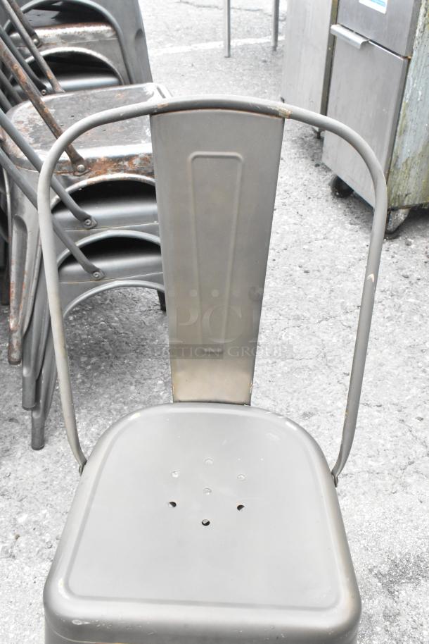 Metal Tolix style dining chair, gray finish, stackable, some surface wear, durable metal construction, 17 available.