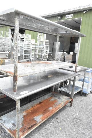 Two stainless steel tables with metal under shelves, dimensions 72x30x35 inches, showing signs of rust and wear.