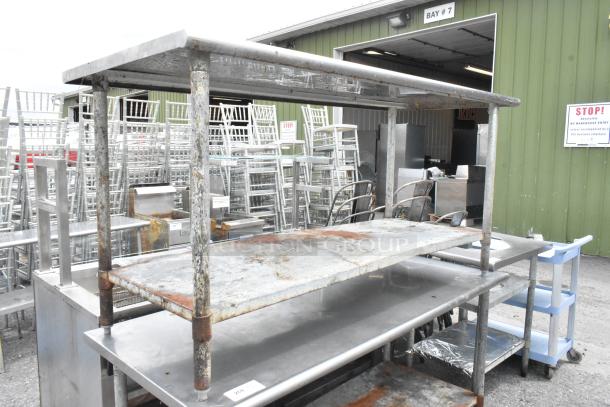 Dual stainless steel tables with metal under shelf, 72x30x35 inches, worn condition, auction item.