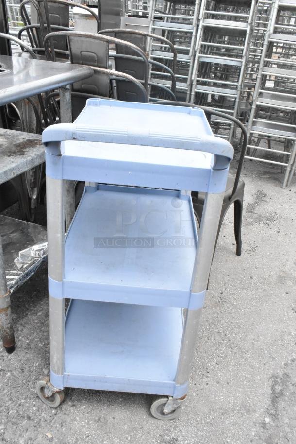 Blue poly 3-tier cart on commercial casters, durable construction, ideal for storage and easy mobility.
