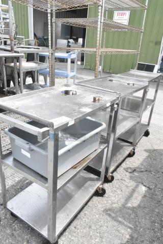 Three stainless steel three-tier carts on commercial casters, used condition, visible rust and wear, ideal for utility storage.
