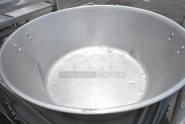 Three large metal bowls, 29x29x9 inches, durable construction, visible surface wear, ideal for industrial use.