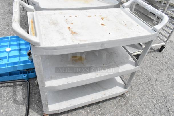 Tan poly 3-tier cart on commercial casters, showing signs of wear and rust, ideal for industrial use.