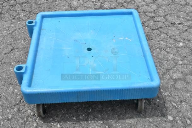 Blue poly dolly on commercial casters, square shape, slightly used. Ideal for moving heavy items.