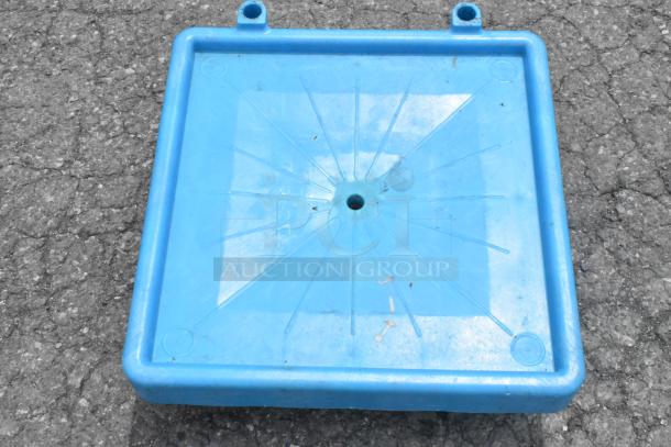 Blue poly dolly with commercial casters, square shape, durable design, slight wear visible, suitable for heavy loads.