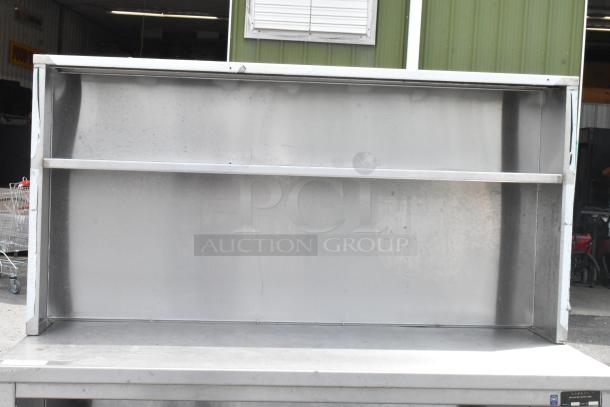 Stainless steel table with overshelf, two under shelves, used condition, ideal for commercial kitchens.