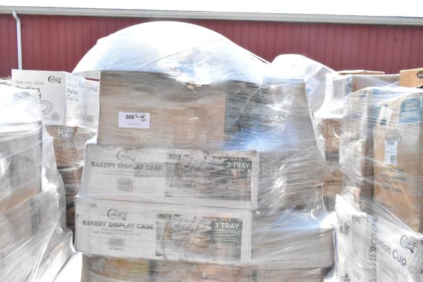 Bulk auction items wrapped in plastic, including Choice bakery display cases and various containers. Scratch and dent condition.