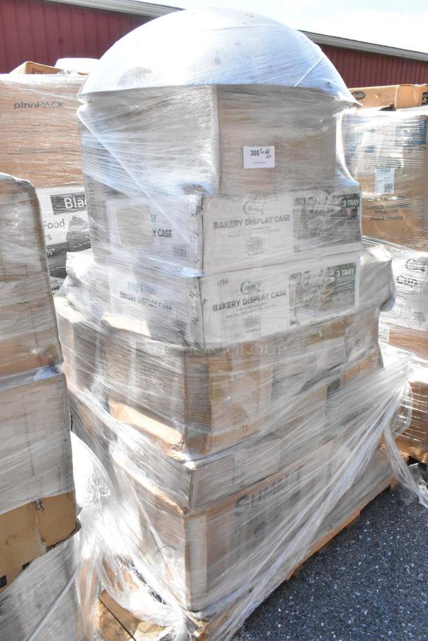 Plastic-wrapped pallet of new scratch and dent items including bakery display cases, labeled "Choice," with visible packaging.