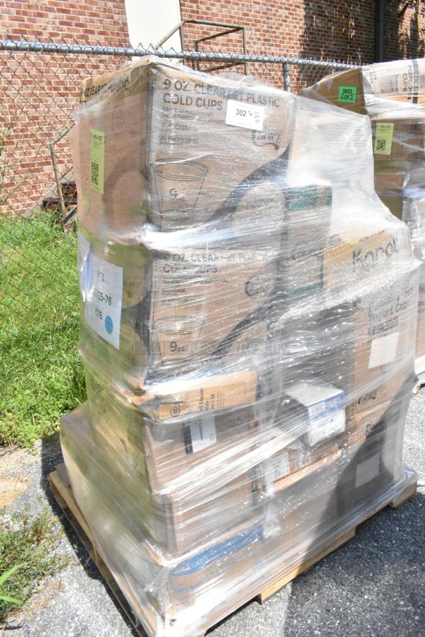 Shrink-wrapped pallet of assorted scratch and dent items including containers, bags, and plates. Visible labels detail contents.