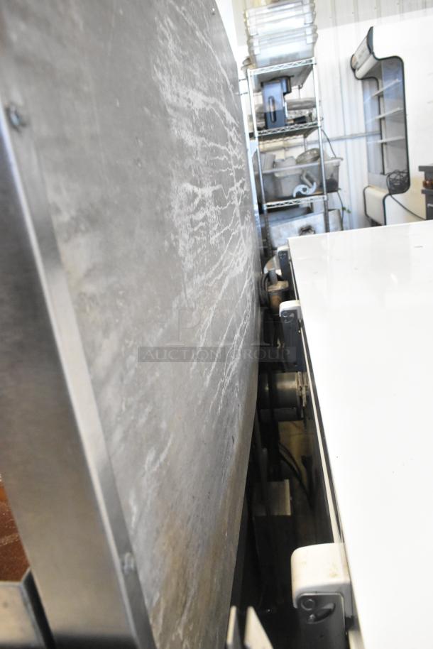 Stainless steel side view of a Vulcan commercial gas range, featuring four burners, a griddle, convection oven, and backsplash.