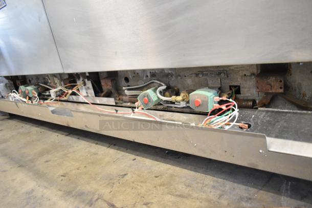 Vulcan stainless steel commercial gas range, 4 burners, flat top griddle, convection oven, standard oven, with shelf.
