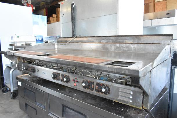 Stainless steel commercial countertop flat top griddle with control knobs. Used condition, suitable for restaurant kitchens.