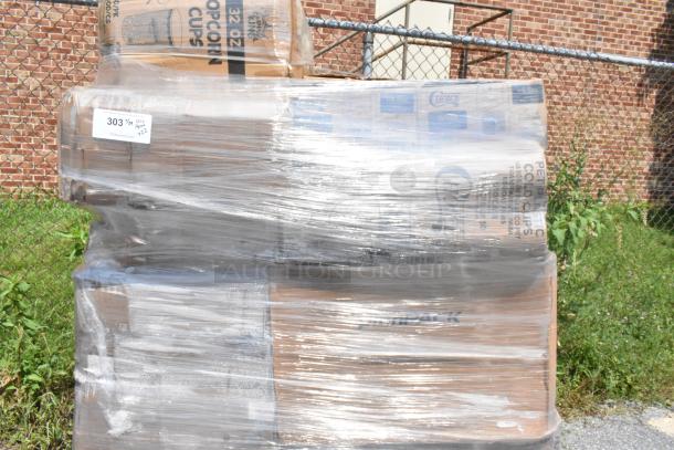 Plastic-wrapped pallet of scratch and dent items, including boxes labeled popcorn cups. Tags with stock number visible.