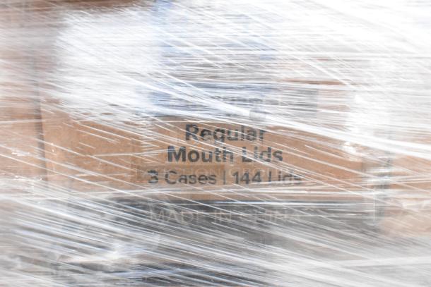 500 boxes of 407REGCL regular mouth lids for canning jars, 48 per pack, shrink-wrapped. Labels read "Regular Mouth Lids, 3 Cases | 144 Lids."