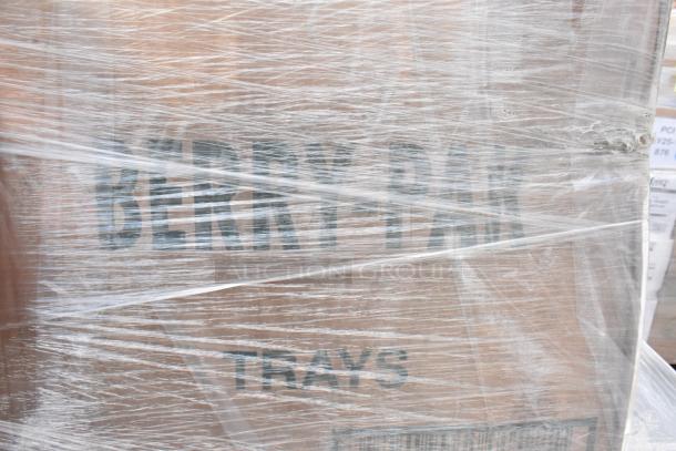 Plastic-wrapped pallet containing scratch and dent items, marked with "BERRY-PAK TRAYS." Includes plastic plates.