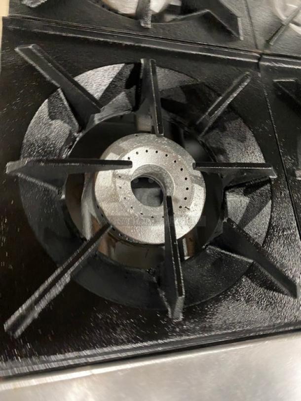 Therma-Tek stainless steel 6-burner range with natural gas power, raised flat griddle, and double oven combo, shown close-up.
