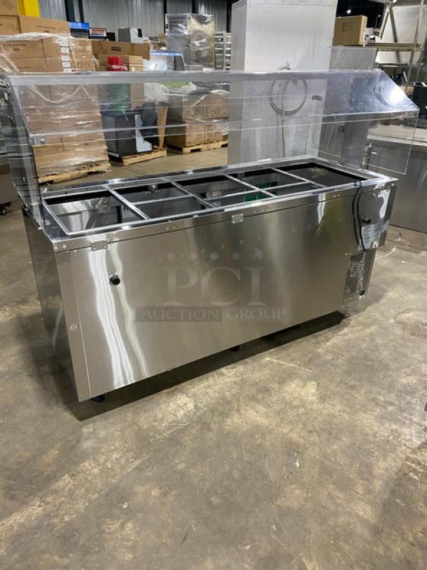 Turbo Air JBT-72-N stainless steel 3-door refrigerated buffet display table, 71", with sneeze guard and wire racks, on casters.