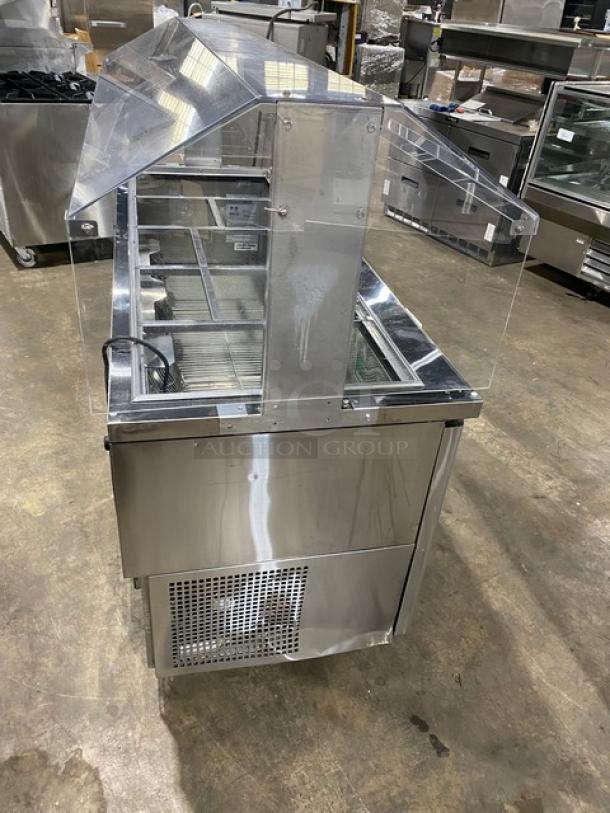 Turbo Air JBT-72-N stainless steel 3-door refrigerated buffet salad bar with sneeze guard, poly-coated wire racks, on casters. 