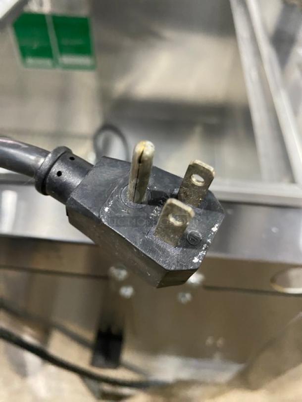 Close-up of a power plug for a Turbo Air JBT-72-N refrigerated salad bar, showing a three-prong plug suitable for 115V.