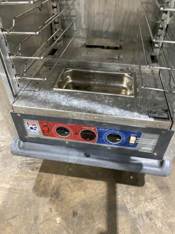 Metro C5-1 Series glass door heated cabinet, Model C519-CFC-U. Features control panel, metal racks, on casters; used condition.