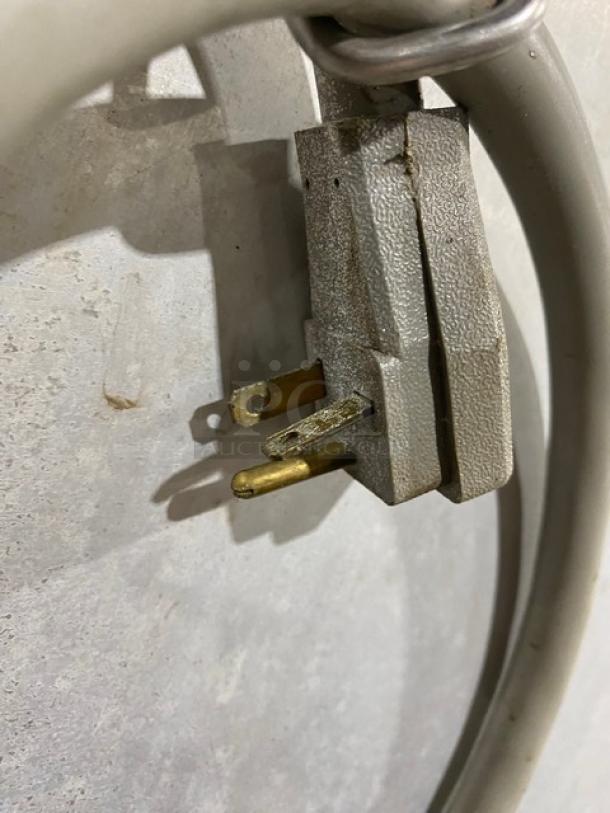 Power cord of Metro C519-CFC-U heated cabinet showing a 120V plug with visible wear and signs of use.