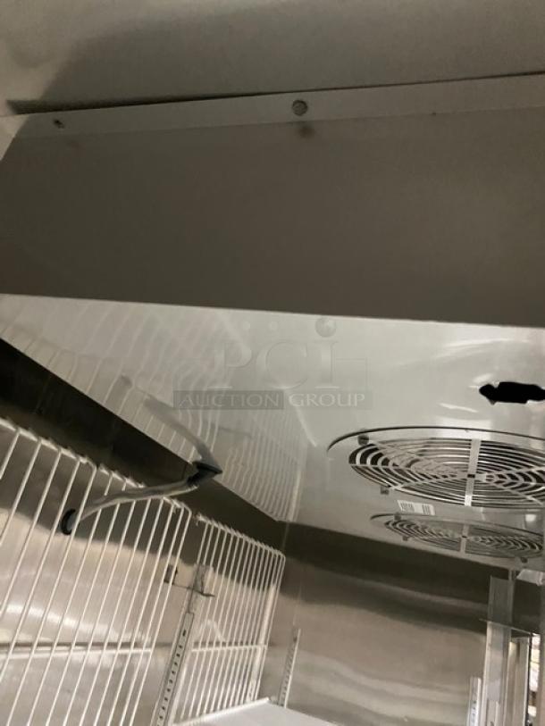 True TS-72F stainless steel 3-door reach-in freezer interior with poly-coated wire racks. Model SN: 5111685, 115/208-230V, 1 Phase.
