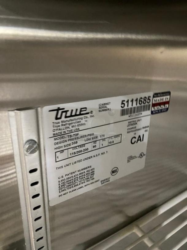 True TS-72F stainless steel commercial 3-door reach-in freezer. Features poly-coated wire racks. Model: TS72F. SN: 5111685.