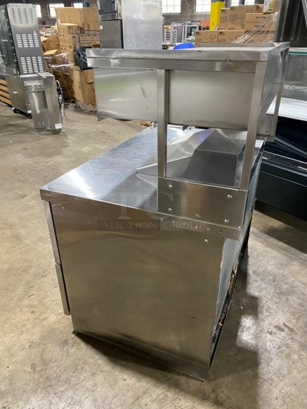 Delfield stainless steel refrigerated prep table, 4 drawers, Bain Marie style, with overhead storage. Good condition.