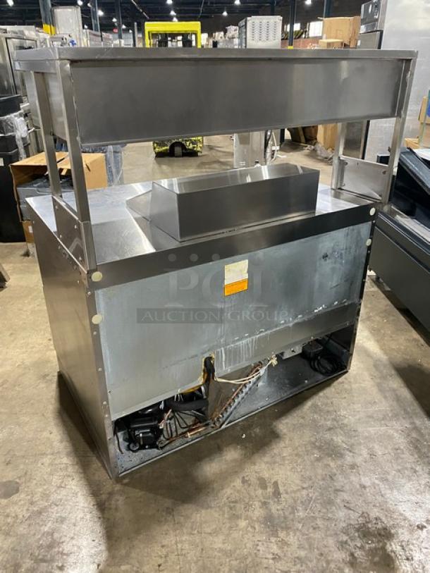 Delfield stainless steel 4-drawer refrigerated bain-marie style prep table with overhead storage. Good condition.