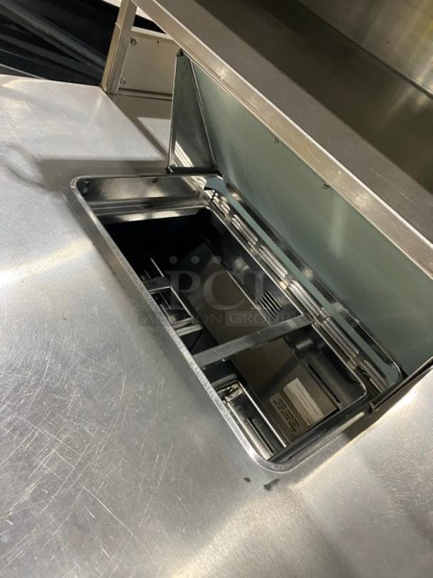 Delfield stainless steel refrigerated prep table with open drawer, Bain Marie style, enclosed overhead storage.