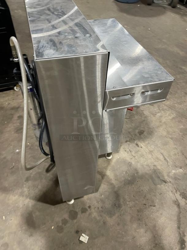 Fetco CBS52H15 countertop twin coffee brewer, stainless steel, with hot water dispenser, 240V, 1 phase, on legs.