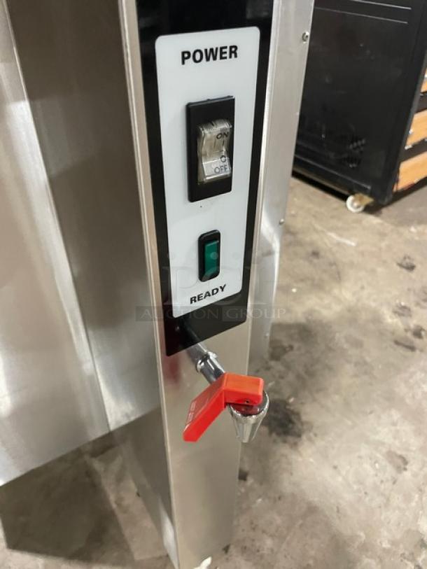 Fetco CBS52H15 commercial coffee brewer with hot water dispenser, stainless steel, 240V, on legs, power and ready switches visible.