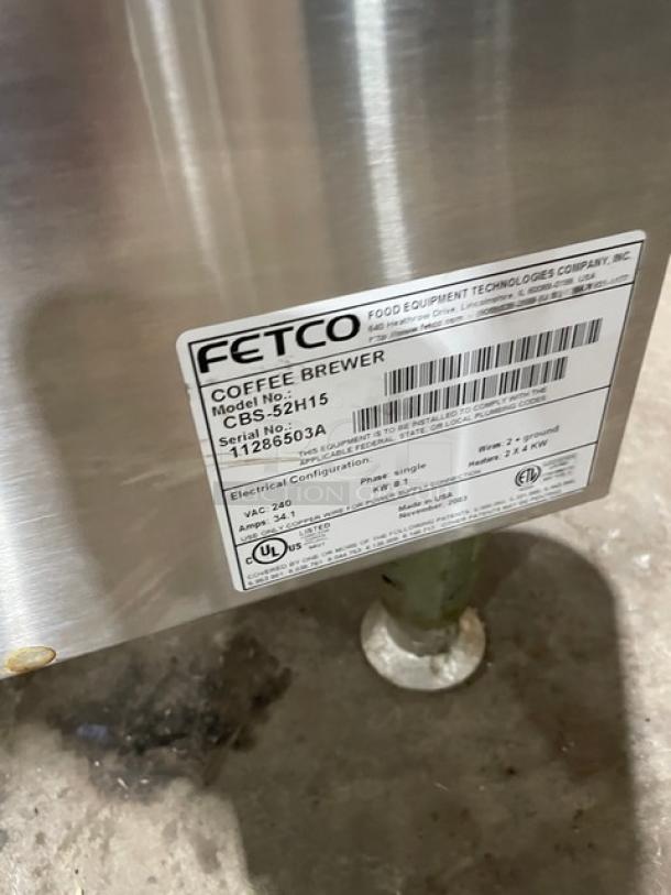 Fetco stainless steel twin coffee brewer, Model CBS52H15, 240V, with hot water dispenser, serial 11286503A, on legs.