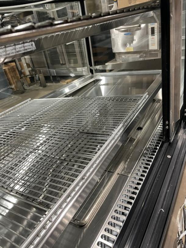 Leader CBK57 57" stainless steel bakery display case with straight glass and adjustable wire racks. Model: CBK57 SN: PT10s2004.