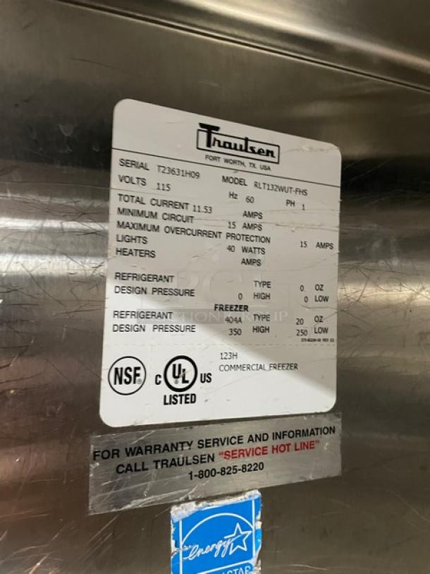 Traulsen stainless steel single door reach-in freezer, Model RLT132WUTFHS, 115V, on legs, Energy Star certified, with visible serial and model labels detailing electrical specifications and refrigerant info.