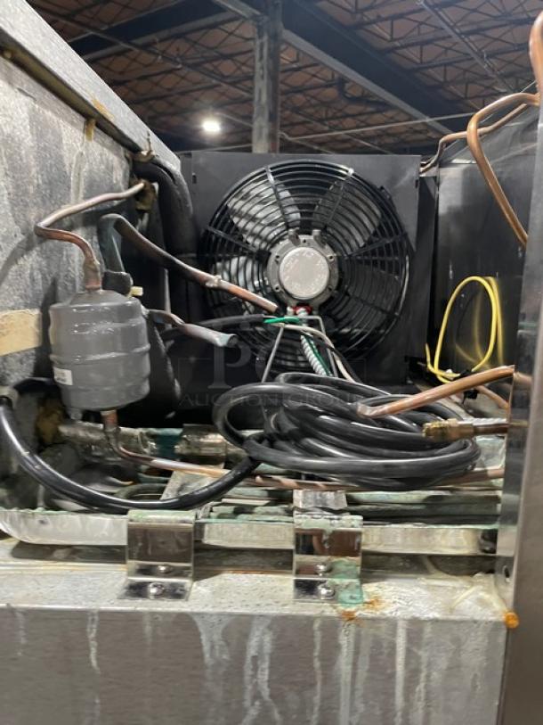 Interior view of Traulsen RLT132WUTFHS commercial freezer components, showing fan and wiring. Signs of wear visible.