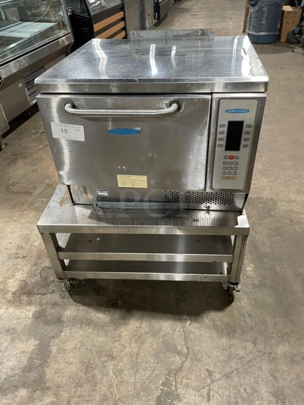 TurboChef NGC stainless steel electric rapid cook oven with digital controls, ventless design, on a caster-equipped double undershelf cart.