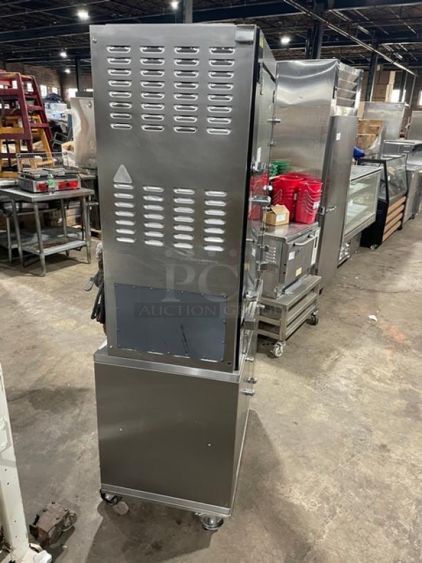 Rotisol Model 950.5 stainless steel natural gas rotisserie oven, tempered glass doors, enclosed cabinet base, on casters.