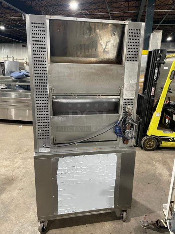 Rotisol 950.5 stainless steel gas rotisserie oven with tempered glass doors, enclosed cabinet base, pull-out workstation, on casters.