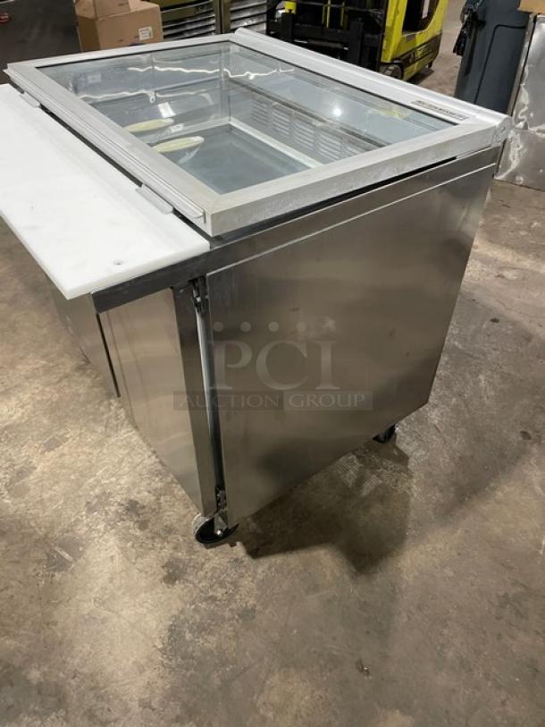 Beverage-Air SPE36HC-15M-STL stainless steel 2-door refrigerated prep table with glass top and cutting board, on casters.