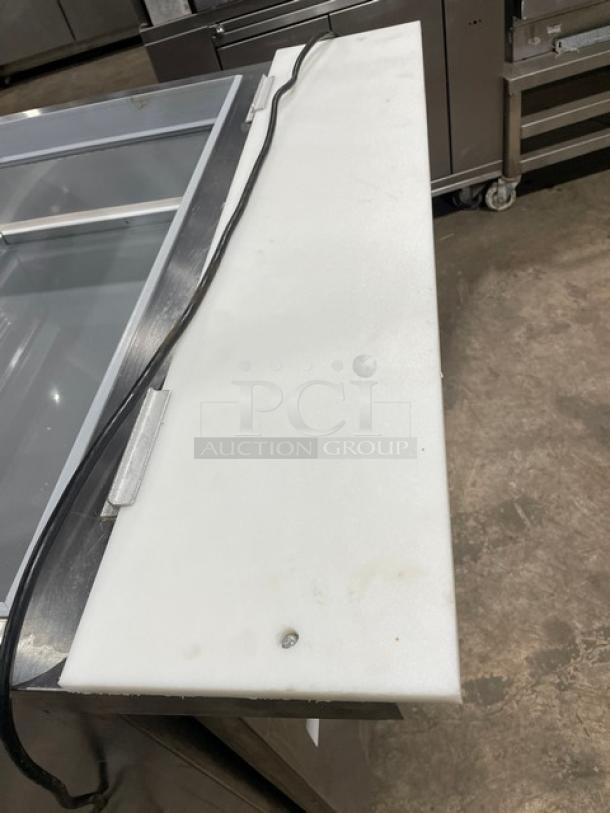Beverage-Air SPE36HC-15M-STL stainless steel 2-door refrigerated prep table with glass top and cutting board, on casters.