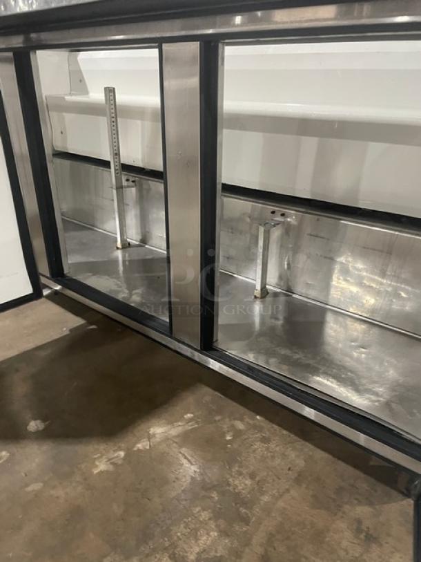 True Commercial 3 Door Refrigerated Prep Table, Model TSSU-72-18, stainless steel, on casters, interior view.