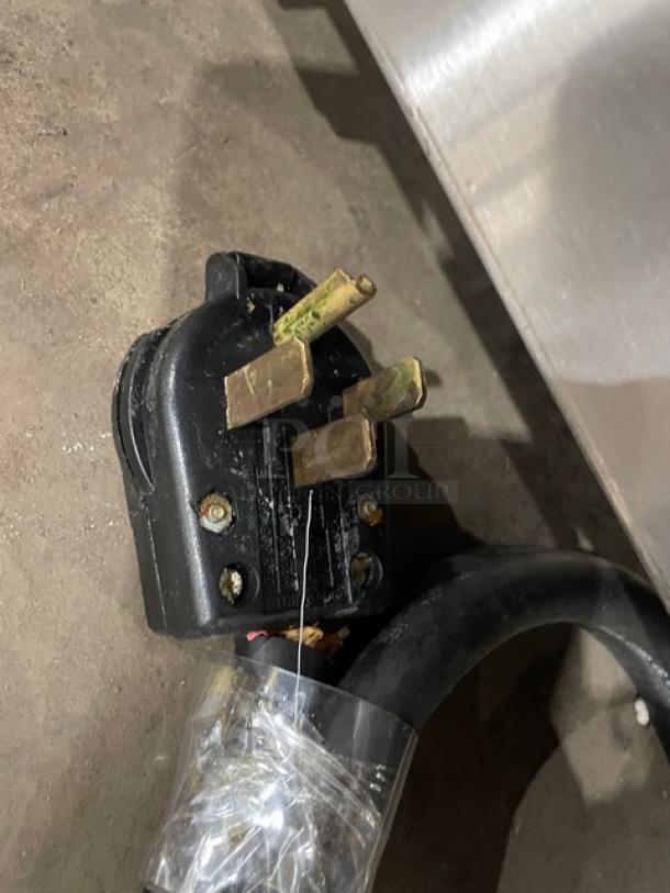 Keating 14CMBB electric fryer plug with three prongs, showing power connection. Model SN: FE35461, 240V, 3 phase.