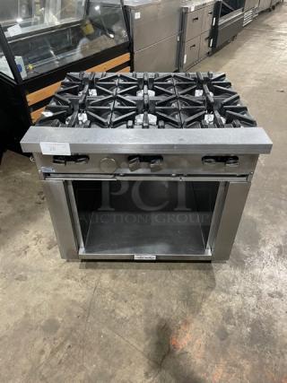 U.S. Range stainless steel 6-burner commercial gas range with enclosed cabinet base on casters. Appears in good condition.