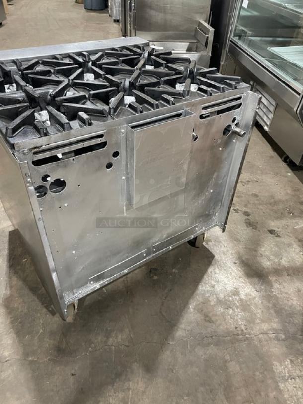 U.S. Range commercial stainless steel 6-burner natural gas range with enclosed cabinet base on casters.