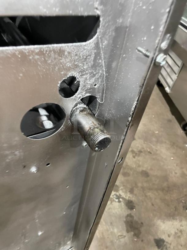 U.S. Range commercial stainless steel natural gas 6-burner range with enclosed cabinet base on casters, visible piping shown.